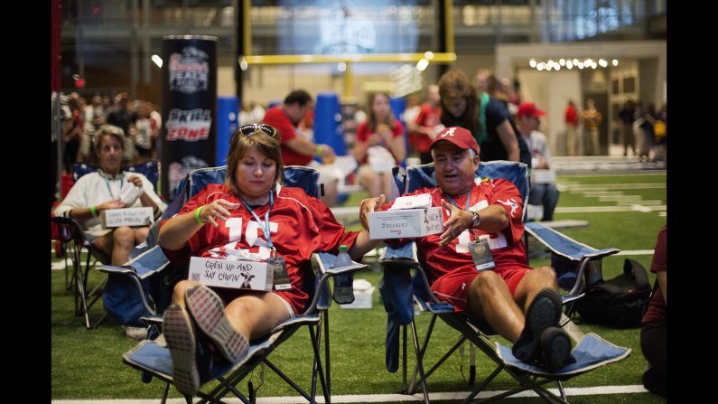Amy and Louis Valenzuela eat dinner at the Hall of Fame during the sleepover. "It's awesome," said Amy, an Alabama fan. "I think I already pulled my back, but it's so much fun."