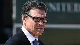 :Texas Governor Rick Perry waits to greet US President Barack Obama in Dallas, Texas, on July 9, 2014 as he arrives for a meeting with local elected officials and faith leaders to discuss the urgent humanitarian situation at the Southwest border. Obama requested $3.7 billion in emergency funding from Congress to help cope with a surge of unaccompanied child immigrants from Central America. AFP PHOTO/Jewel Samad (Photo credit should read JEWEL SAMAD/AFP/Getty Images)