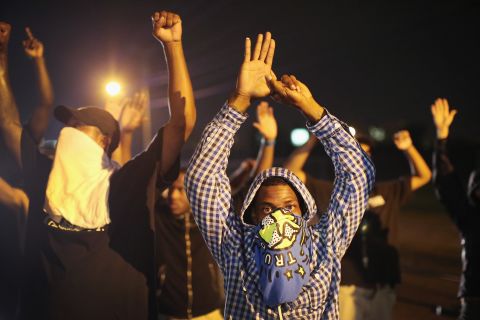 Demonstrators protest with their hands up on August 15, 2014. The "hands up" gesture has become a symbol in protests as Brown, according to eyewitnesses, was trying to surrender when he was shot multiple times.