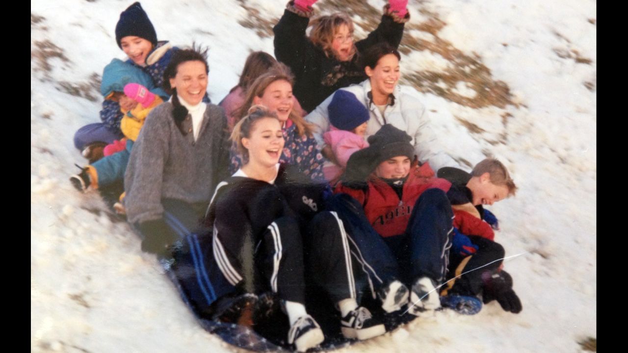 Cynthia Scudo sleds with all of her eight children.