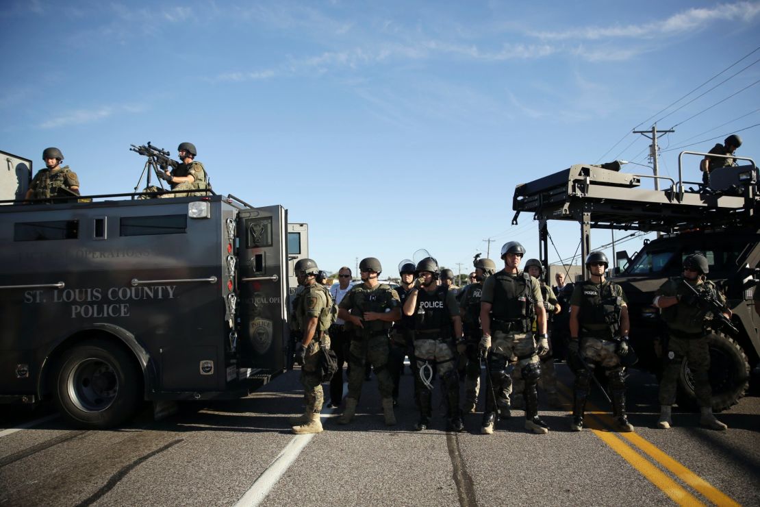 Police in riot gear watch protesters in Ferguson, Missouri, on Wednesday.