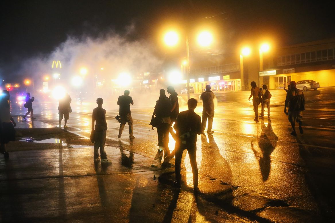 Police fire tear gas at demonstrators after curfew on August 17, 2014. 