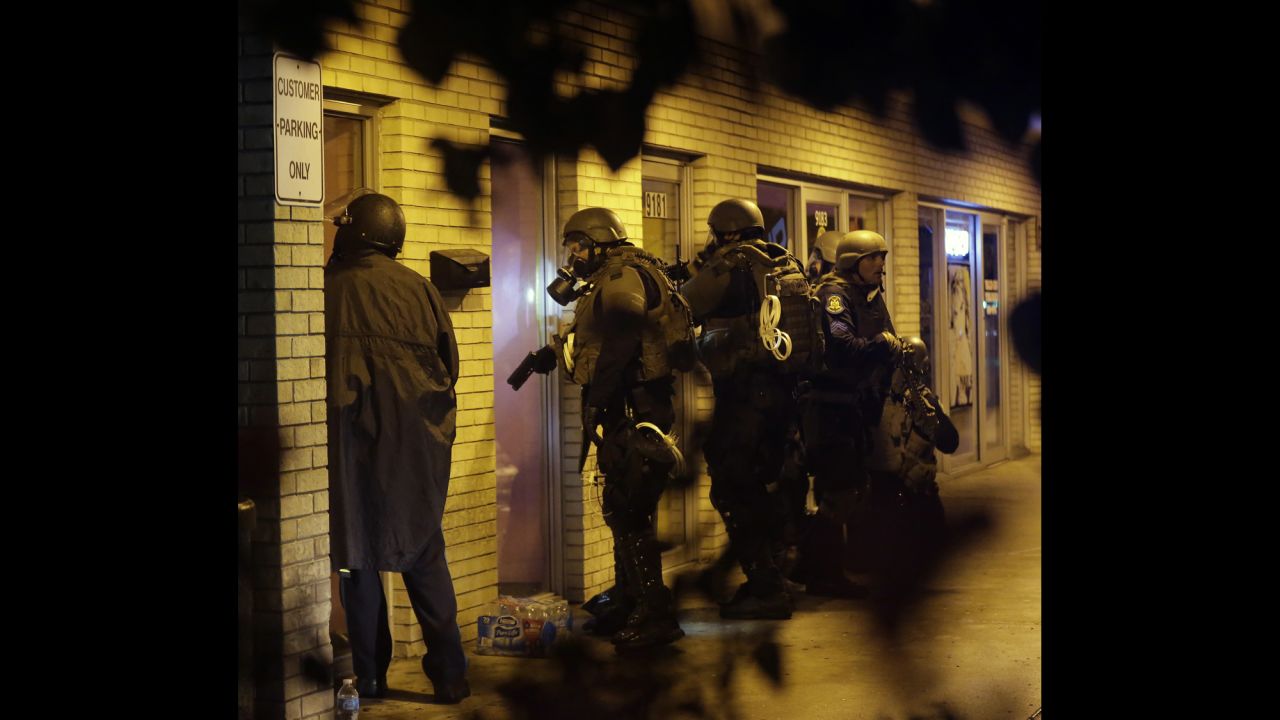 Law enforcement officers check a building on August 17, 2014. 
