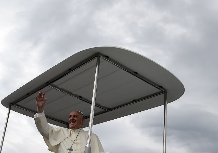 Pope Francis blesses the faithful on August 17 as he arrives for Mass. 