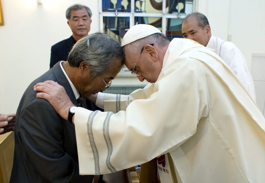 In Seoul on August 17, Pope Francis greets the father of one of the victims of the sinking of a South Korean ferry that killed more than 300 people, most of them high school students, earlier this year.