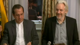 Julian Assange smiling at press conference