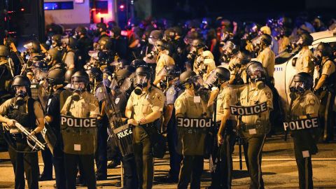 A large group of police officers advance toward protesters on August 17, 2014.