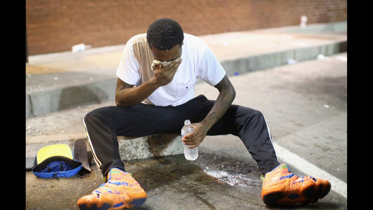 A man fights the effects of tear gas in Ferguson on August 17, 2014.