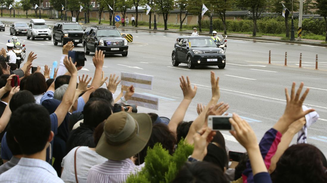 Pope Francis waves to crowds from inside a vehicle near Seoul Air Base in Seongnam on Monday, August 18. The Pope's trip to South Korea marks the first papal visit to the country since Pope John Paul II went there 25 years ago.