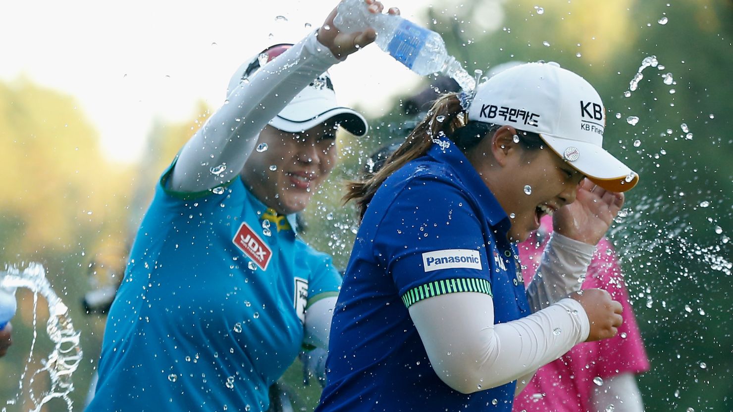 Meena Lee (L) sprays water on Inbee Park after the South Korea beats Brittany Lincicome on the first playoff hole at Monroe Golf Club.
