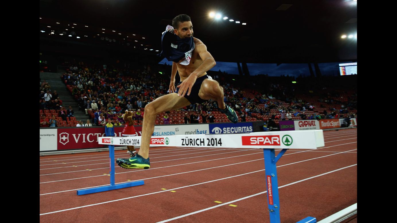 France's Mahiedine Mekhissi-Benabbad leaps over the final barrier on his way to winning the 3,000-meter steeplechase final Thursday, August 14, at the European Athletics Championships in Zurich, Switzerland. But <a href="http://www.cnn.com/2014/08/14/sport/athletics-mekhissi-benabbad-vest-gold/">he was later disqualified</a> for his shirtless celebration in the last stretch of the race.