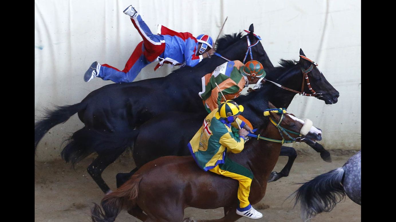 Jockey Sebastiano Murtas, left, crashes during the Palio di Siena horse race Saturday, August 16, in Siena, Italy. Twice a year, 10 riders — each representing one of Siena's city wards — compete in the bareback race around Siena's shell-shaped central square.