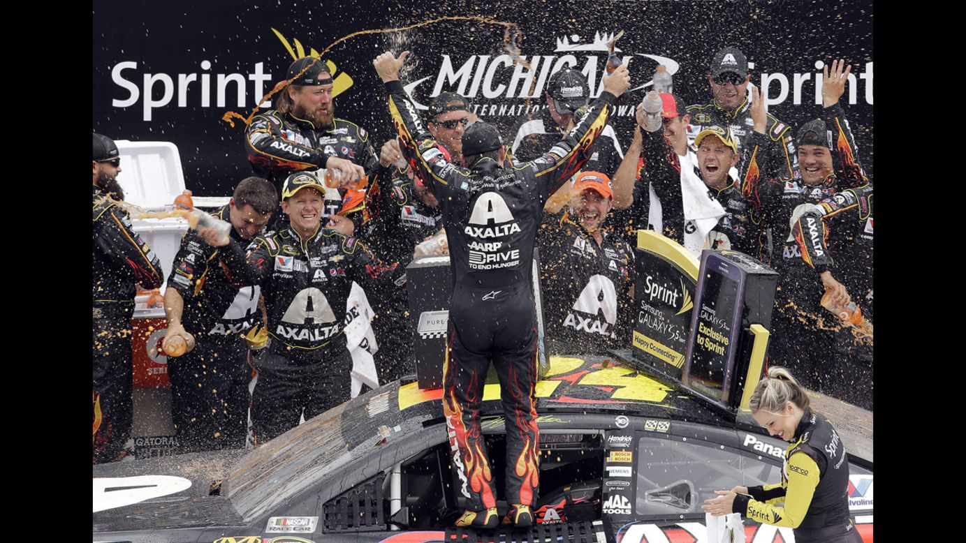 NASCAR driver Jeff Gordon celebrates with his crew after winning the Sprint Cup race at Michigan International Speedway on Sunday, August 17. It was his third victory of the year.