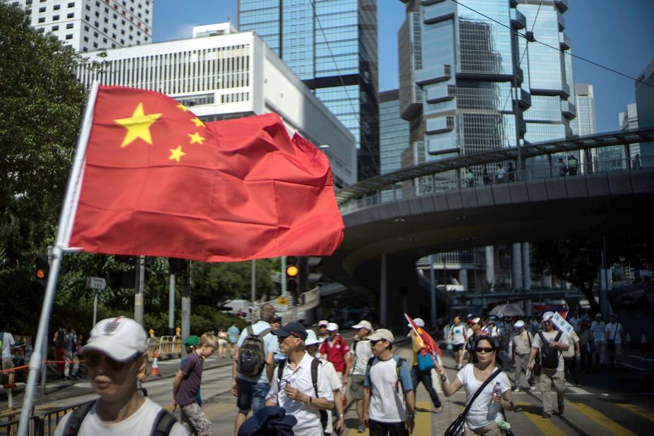 A group of pro-China protesters marches in downtown Hong Kong on August 17. Local media accused organizers of paying people to participate in the Anti-Occupy Central protest.