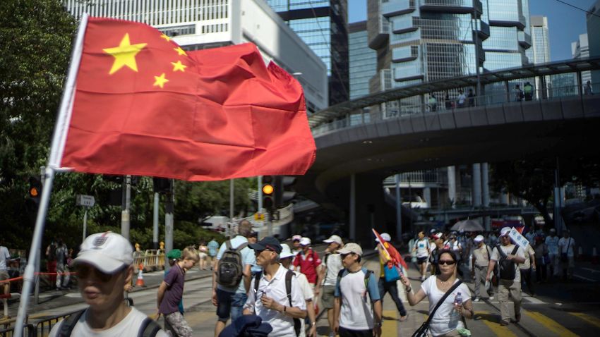 A anti-Occupy Central supporter carry a Chinese national flag during the march on August 17, 2014 in Hong Kong. Organised by the Alliance for Peace and Democracy, the anti-Occupy Central march runs along the route from Victoria Park in Causeway Bay to Chater Road in Central. on August 17, 2014 in Hong Kong, Hong Kong. (Photo by Lam Yik Fei/Getty Images)