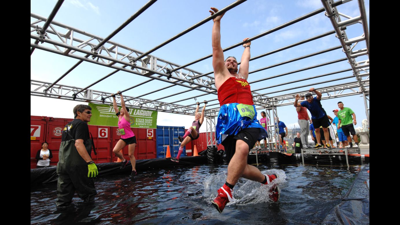 People take part in the annual Concrete Hero obstacle race to raise money for cancer research Sunday, August 17, in Vancouver, British Columbia. More than $550,000 has been raised through the race in the past two years.