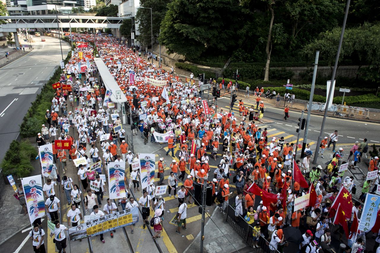 Tens of thousands of people marched through Hong Kong on Sunday, August 17 in support of China and to protest Occupy Central, a pro-democracy movement that says it will plan to stage a civil disobedience sit-in unless the Chinese government allows the Hong Kong public to nominate and vote for its next leader.