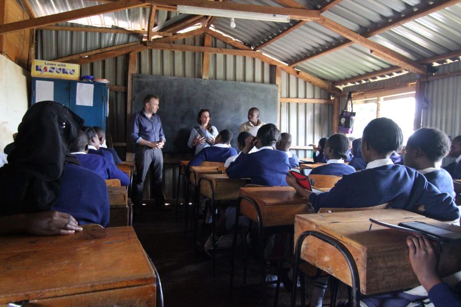 The Kibera Girls Soccer Academy is a free public school for girls (and now some boys). Worldreader co-founder Colin McElwee, left, talks to a class on a recent visit.