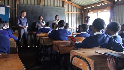 The Kibera Girls Soccer Academy is a free public school for girls (and now some boys). Worldreader co-founder Colin McElwee, left, talks to a class on a recent visit.