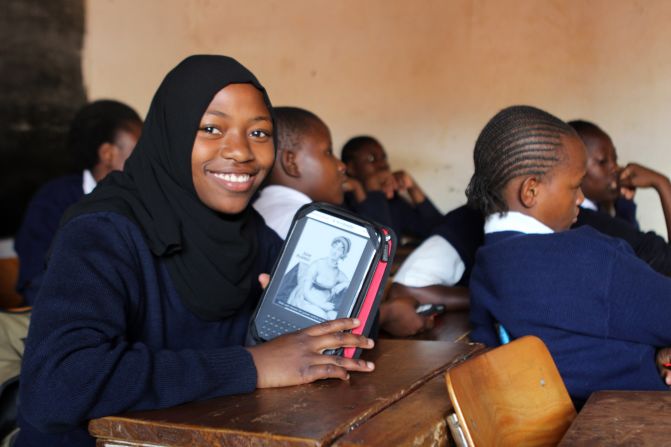 Worldreader is a nonprofit that brings e-readers and e-books to students in developing countries as a way to facilitate literacy. A student in Kibera, Kenya, displays her e-reader in a classroom. 