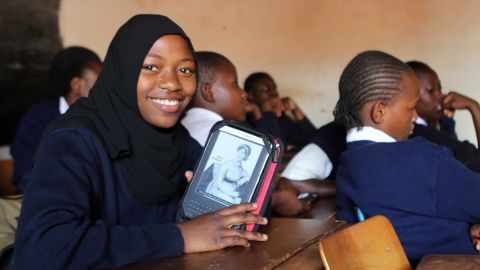 Worldreader is a nonprofit that brings e-readers and e-books to students in developing countries as a way to facilitate literacy. A student in Kibera, Kenya, displays her e-reader in a classroom.