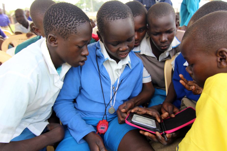 E-readers are still something of a novelty in some remote areas of Kenya. Students gather around a device in Amogoro, a town near the country's western border.
