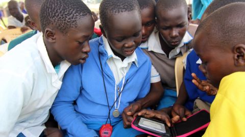 E-readers are still something of a novelty in some remote areas of Kenya. Students gather around a device in Amogoro, a town near the country's western border.