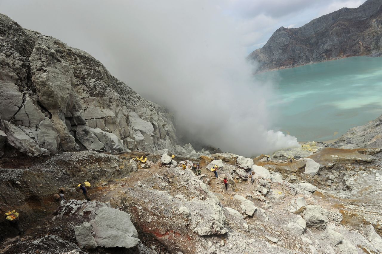 The deceivingly inviting turquoise lake of Kawah Ijen in Indonesia is composed of sulfuric acid. The volcano is famous for "blue fire" caused by sulfur gas burning as liquid sulfur cools into yellow blocks that miners cart away. It's best to watch your step on a volcano, even more so with a skin-melting lake.