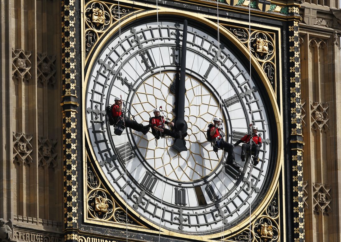 AUGUST 18 - LONDON, ENGLAND: Workers hang in front of the clock face of Big Ben as they clean the city's landmark timepiece at the Houses of Parliament in Westminster. <a href="http://cnn.com/2013/10/15/world/europe/big-ben-fast-facts/">The name "Big Ben" originally referred to just the bell of the clock,</a> but has also come to indicate the clock, the tower and the bell.