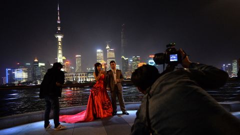 A Chinese couple poses for their wedding photos on Shanghai's Bund. Divorce rates in China have soared in recent years.