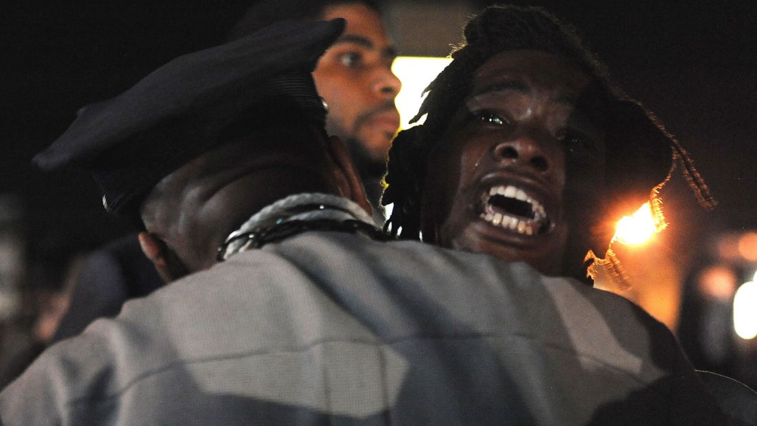 A demonstrator shouts during a protest on West Florissant Avenue, one of Ferguson's main streets, on August 18, 2014.