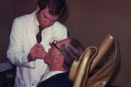 Sandy Halperin was a teacher and practicing prosthodontist at Harvard University in 1979. In this photo he is working on his father, Leon's, teeth.