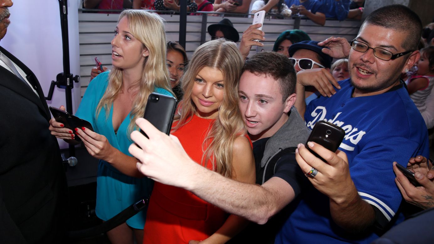 Singer Fergie smiles for a fan Thursday, August 14, at a launch event for #MoreKisses, a campaign organized by the Wet N Wild cosmetics company to benefit the American Cancer Society. According to the company, 25 cents of each Think Pink lipstick sold will be donated to the health organization. 
