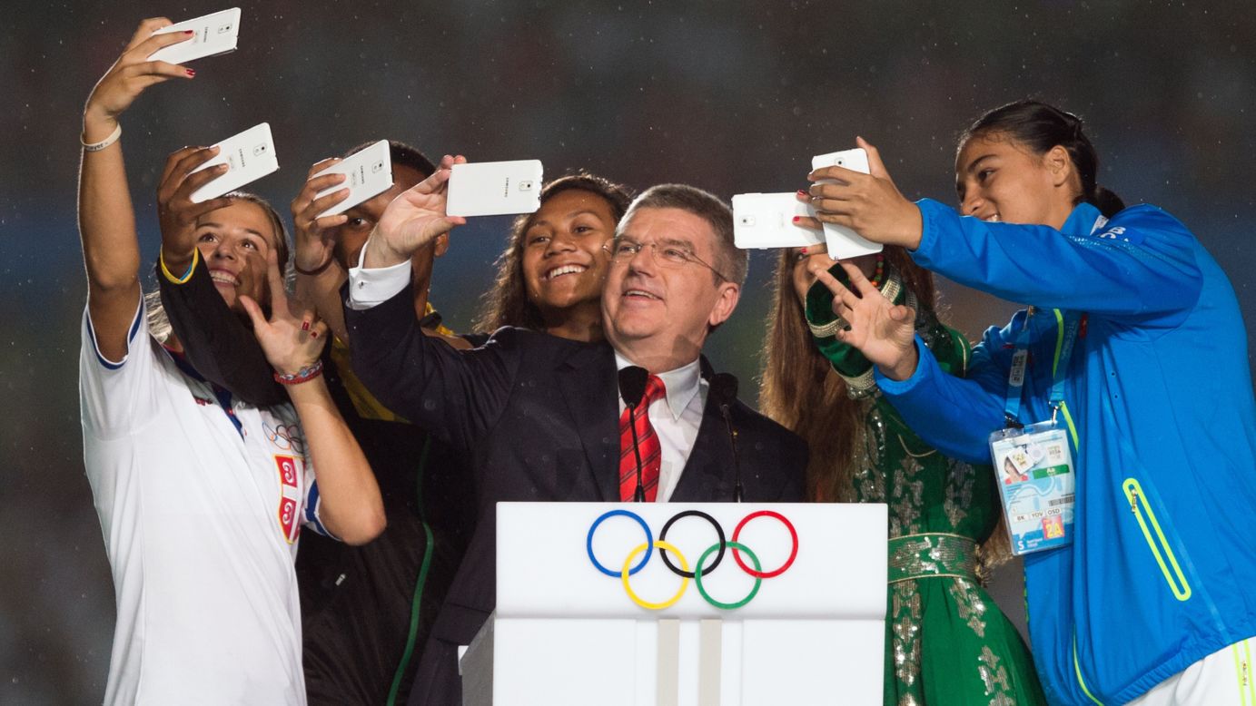 Thomas Bach, president of the International Olympic Committee, snaps a selfie along with some athletes on Saturday, August 16, during the opening ceremony for the Youth Olympic Games in Nanjing, China.