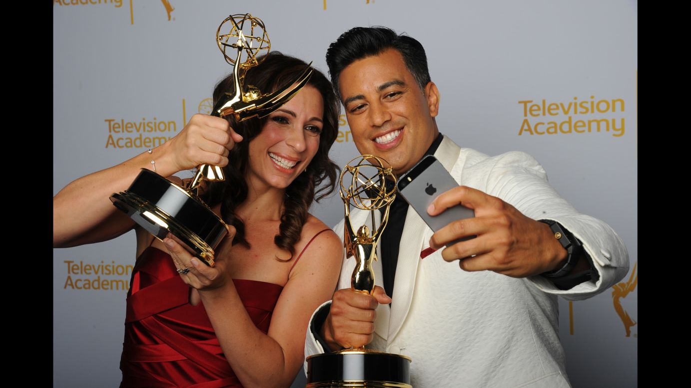 Choreographers Tabitha D'umo and her husband, Napoleon, pose Saturday, August 16, with the Creative Arts Emmys they won for their work on the television show "So You Think You Can Dance."