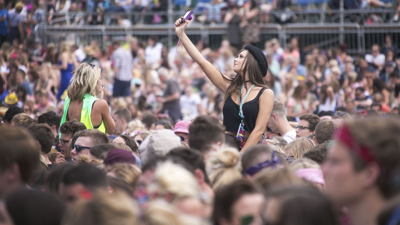 A festivalgoer takes a selfie during a V Festival concert Saturday, August 16, in Chelmsford, England.