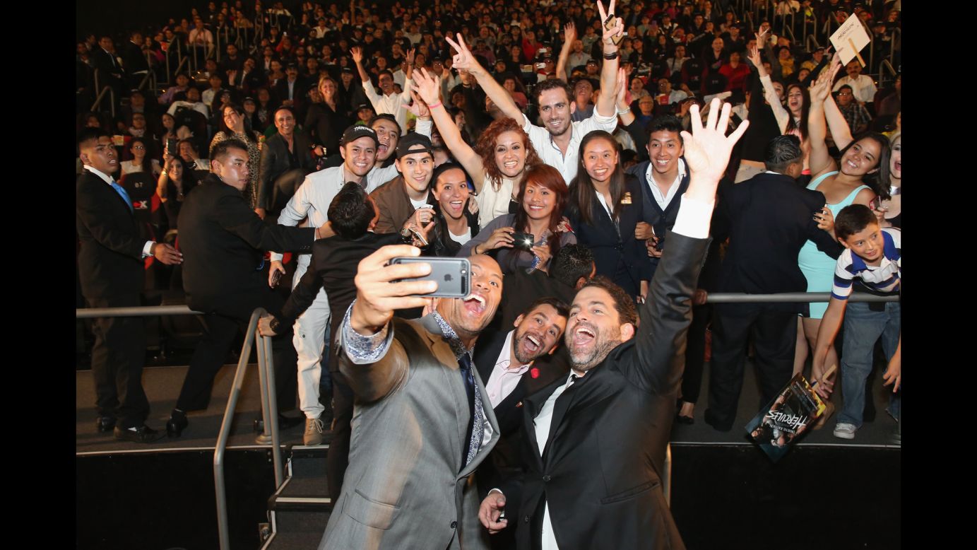 Actor Dwayne Johnson takes a photo with fans and director Brett Ratner, right, at the Latin American premiere of "Hercules" on Monday, August 18, in Mexico City. <a href="http://www.cnn.com/2014/08/13/world/gallery/look-at-me-0813/index.html">See 20 selfies from last week</a>