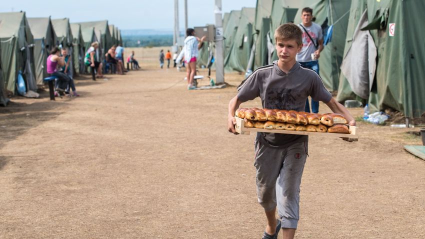 A boy carries pastries in refugee camp near the Russian city of Donets'k, Rostov region, about 15 kilometers from the Russian-Ukrainian border. Some 285,000 people have already fled their homes due to the conflict in east Ukraine, it is estimated, with many leaving for other parts of the country, but close to 168,000 seeking sanctuary in Russia. AFP PHOTO / DMITRY SEREBRYAKOVDMITRY SEREBRYAKOV/AFP/Getty Images