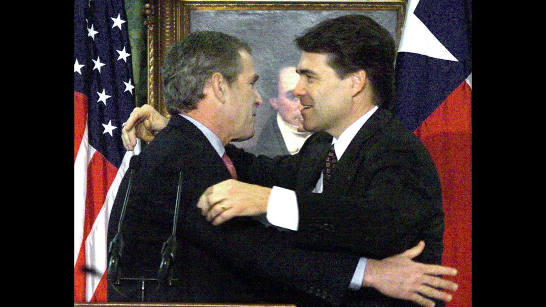 Perry, then the lieutenant governor of Texas, hugs George W. Bush before being sworn in as governor on December 21, 2000, in Austin. Bush had been elected president and was resigning as governor.