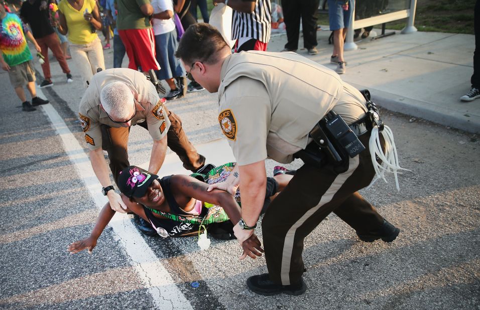 A demonstrator is arrested on August 19, 2014.