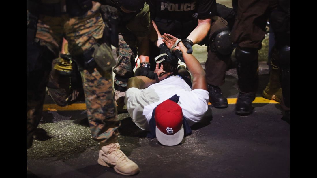 Police arrest a demonstrator on August 19, 2014.