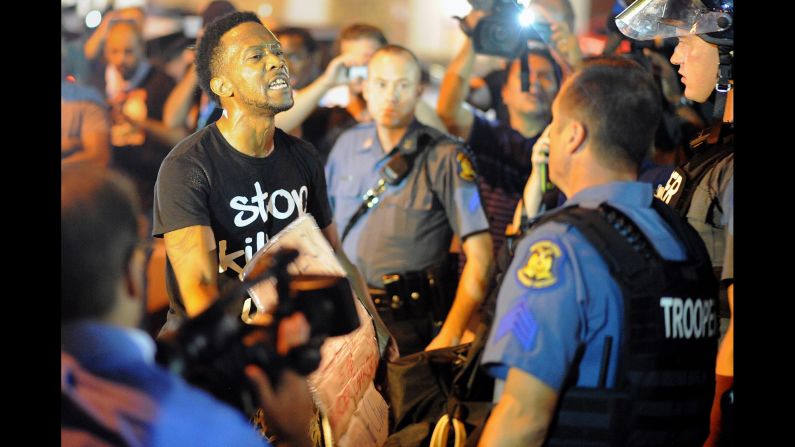 A protester speaks to a police officer on August 19, 2014.