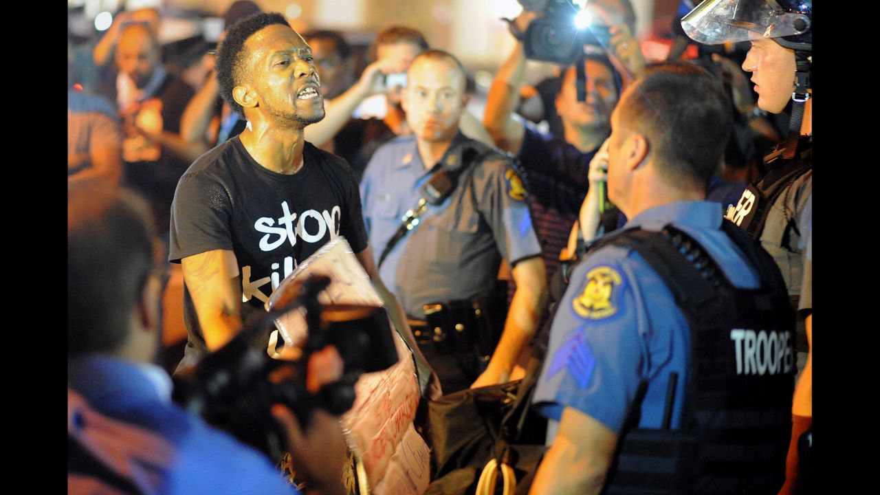 A protester speaks to a police officer on August 19.