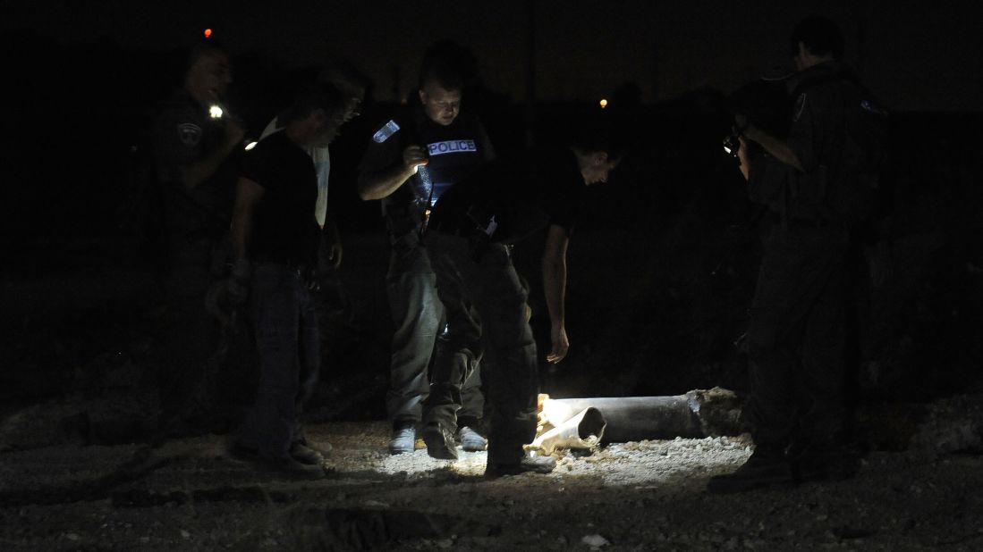 Police examine the remains of a rocket launched from Gaza that landed near the kibbutz of Yad Mordechay on August 19.