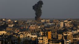 Smoke and dust rise after an Israeli air strike hit Gaza City on August 19.