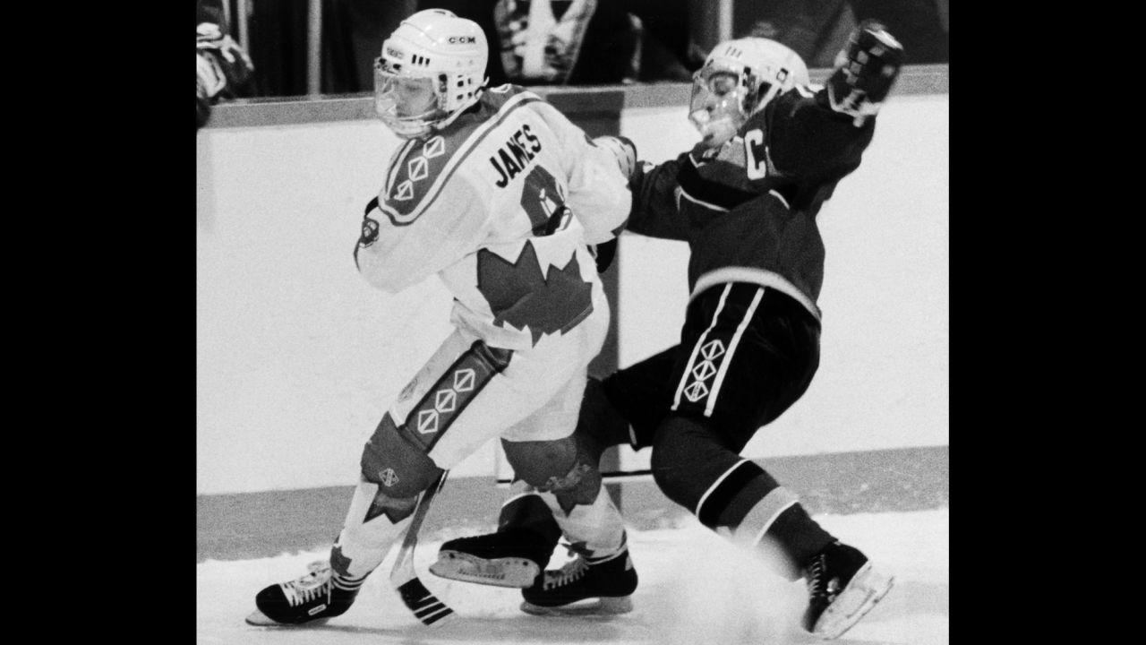 Canada's Angela James, left, checks Germany's Elvira Saager during the Women's World Hockey Championships in Ottawa in 2010.