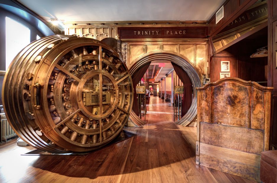 A set of two century-old 35-ton doors lead to the former underground vaults of the United States Realty Bank in New York. The first room of Trinity Place is a buzzy lounge area, while the second is a dining room.