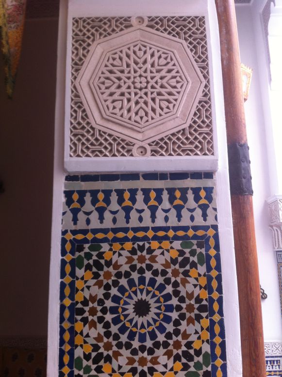 Riad El Amine in Fez features ornamentation from traditional Moroccan crafts such as zellij (glazed ceramic tiles) in colorful geometric patterns on walls and floors.