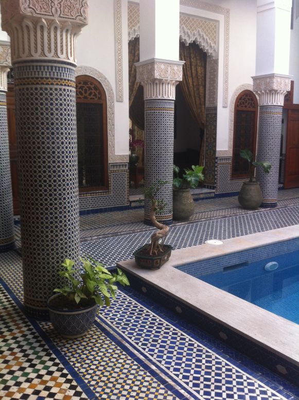 Riad El Amine's courtyard has zellij-adorned columns surrounding an aqua-tiled reflecting pool.