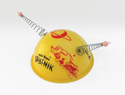 Wee Beep Sputnik hat (1957), with sprung antennas and space dog theme. "Wee Beep" refers to the sound emitted by the first Sputnik, which could be heard by anyone with a short-wave radio. Visible from the Earth through a telescope, it prompted a wave of Sputnik mania.